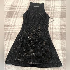 Black sequined cocktail dress. Zips in back. Size 7/8 New w/o tags.